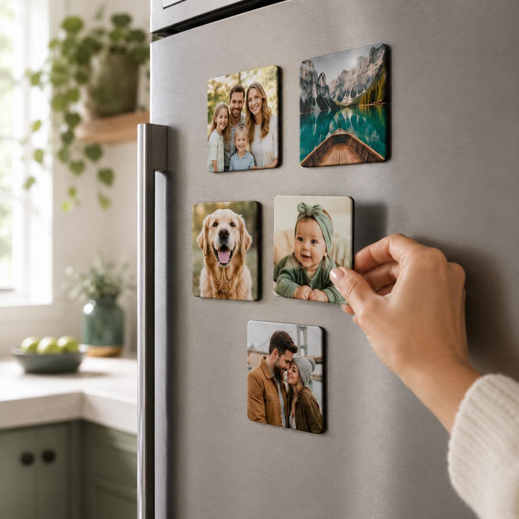 Hand placing a custom photo fridge magnet onto a fridge door in a bright kitchen